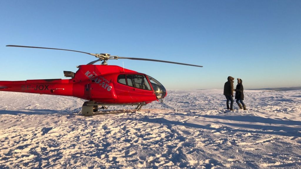 A helicopter on the snow during production of Bachelor season 21 in Lapland