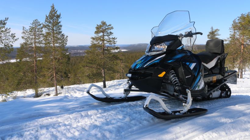 Snowmobile in the forest Lapland