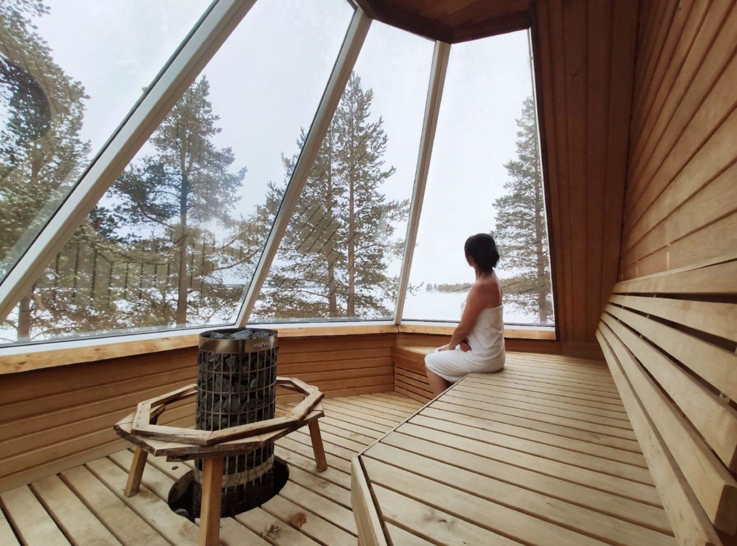 Enjoying a winter afternoon in the aurora sauna at Wilderness Hotel Inari in Inari, Finland