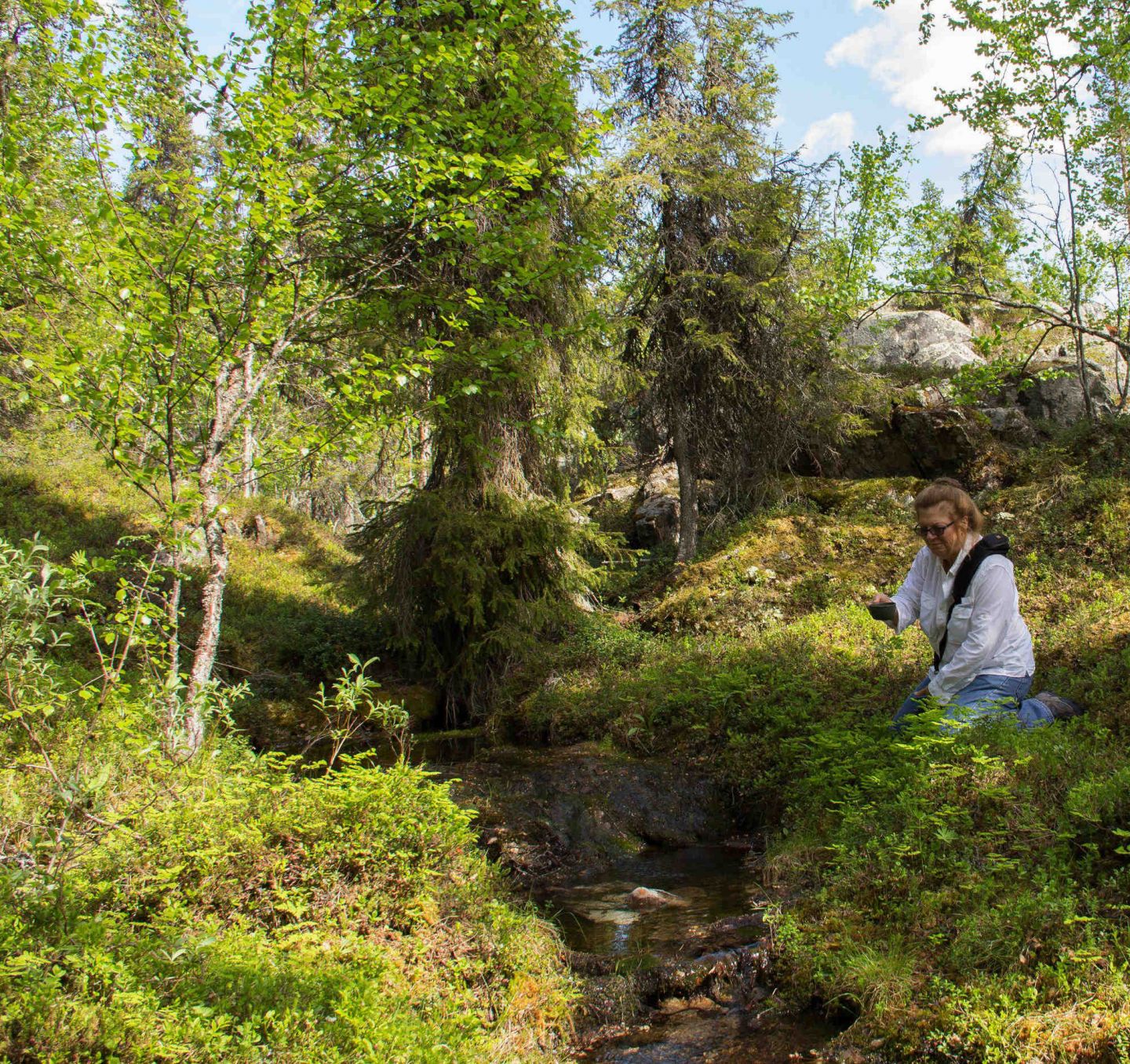 Location scout Lori Balton explores a Lapland forest, during a fam trip with location scout Lori Balton