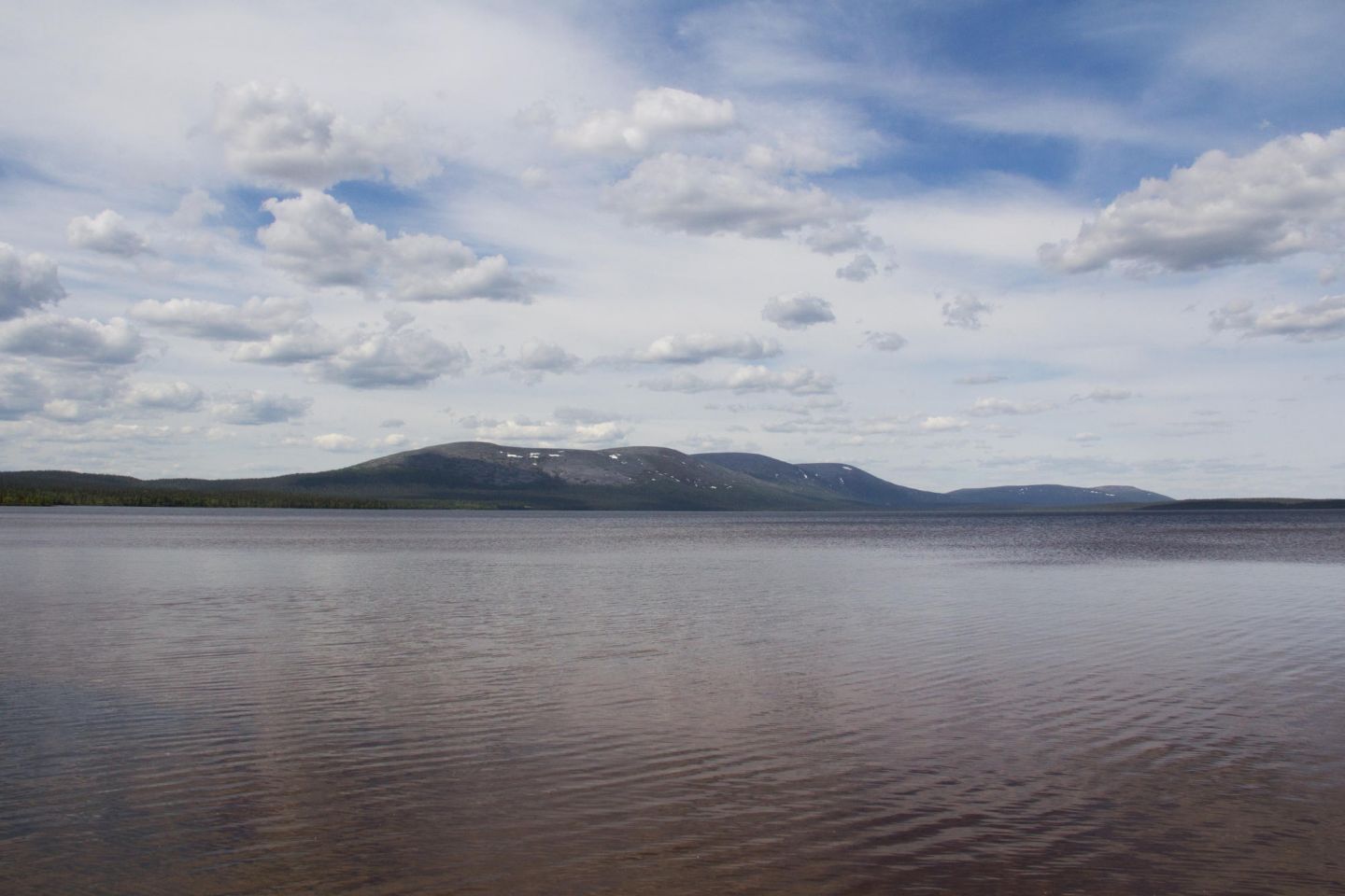 Lapland lake with hill on horizon, during a fam trip with location scout Lori Balton