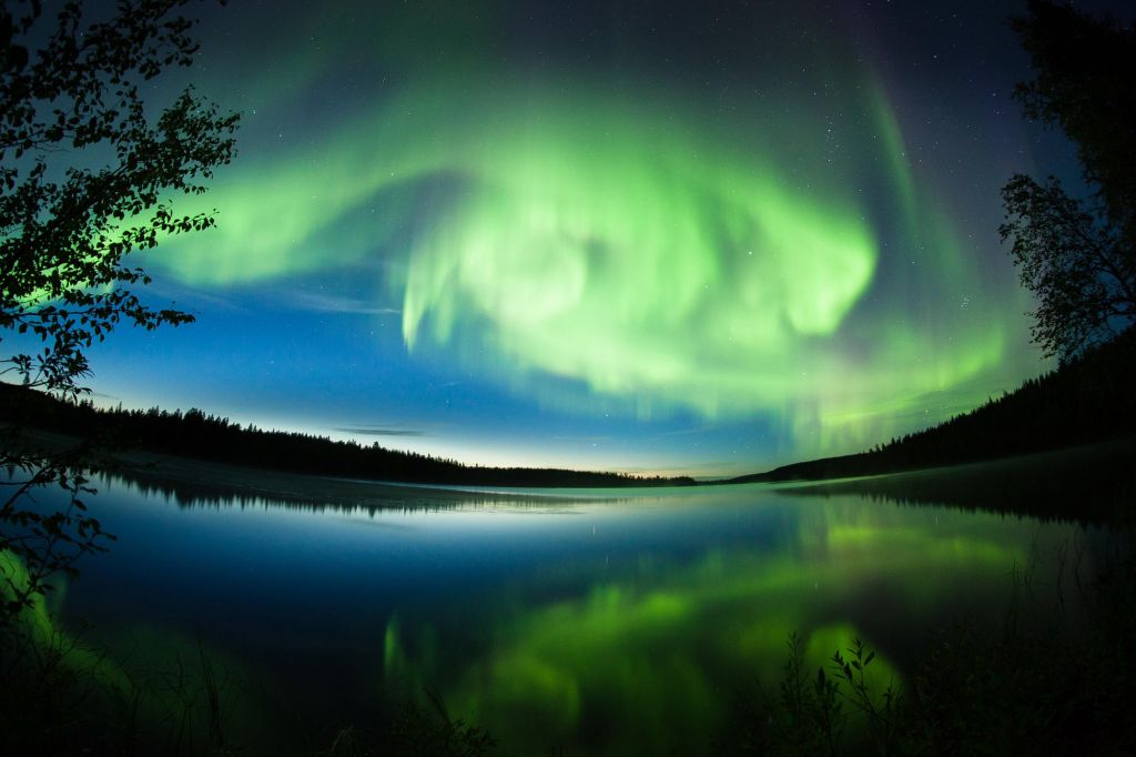 Fish-eye Northern Lights and reflection in Lapland