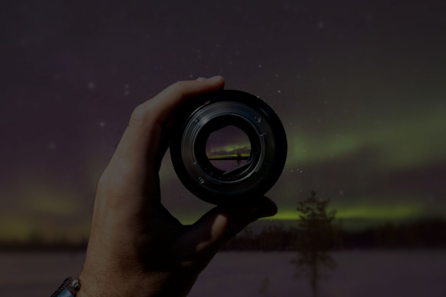 Close-up of northern lights in a camera lens in Finnish Lapland