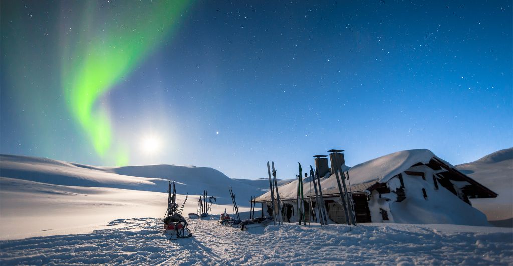auroras over a winter cabin