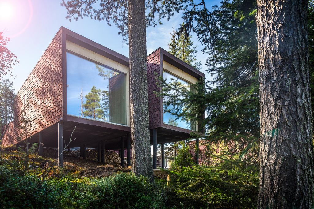 Outside the suite of award-winning Arctic TreeHouse Hotel in summer in Finland