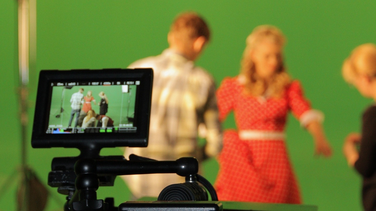 actors in front of a green screen