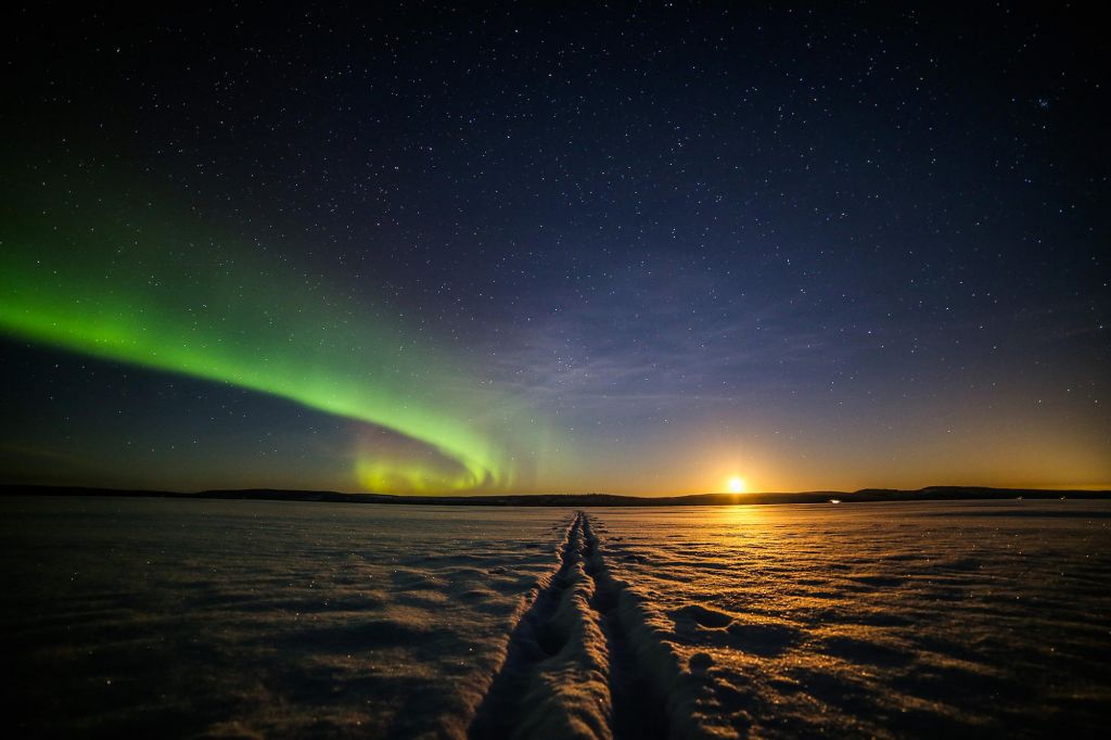 Northern Lights above a frozen lake in Finland in winter