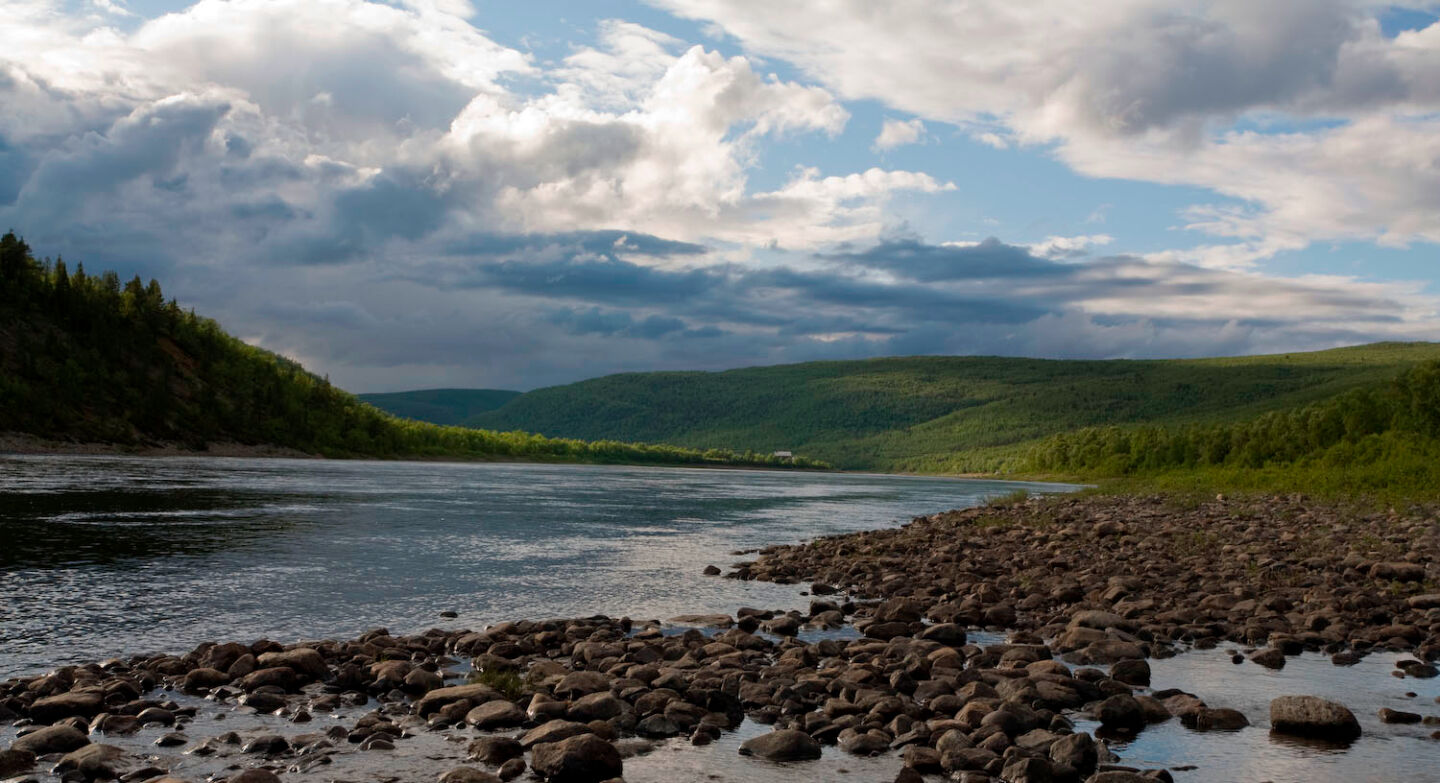 Stony riverbank in Utsjoki, Finland in summer, a stand-in location for Scotland