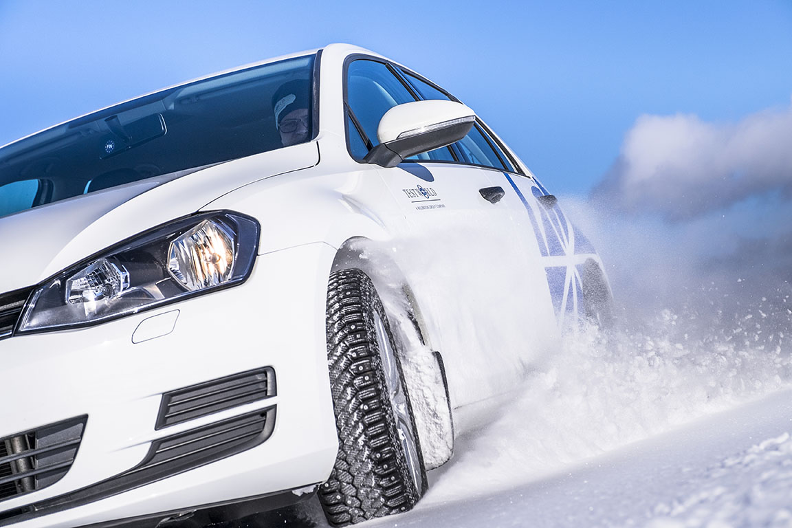 White car speeding through the snow