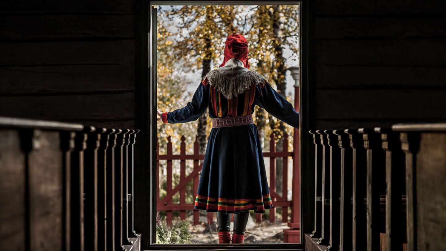 A Sámi woman in a traditional church in Inari-Saariselkä, Finland