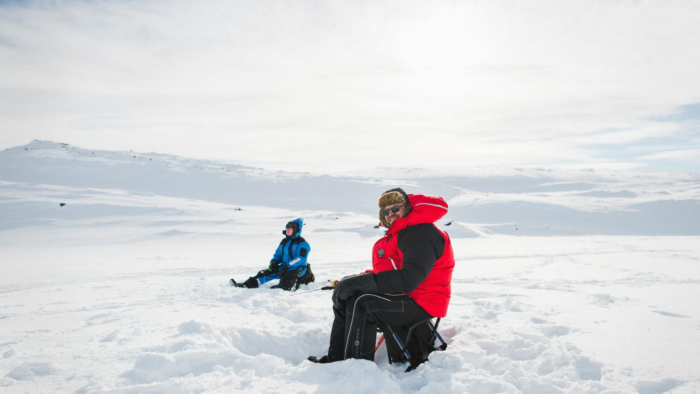 Ice-fishing under the Lapland winter sun