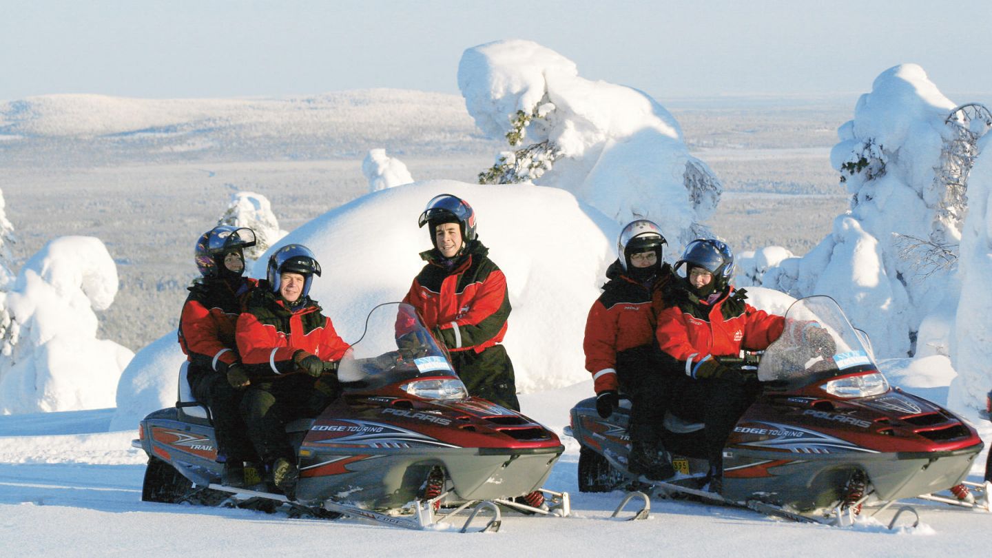 Snowmobiles under the winter sun in Lapland, Finland
