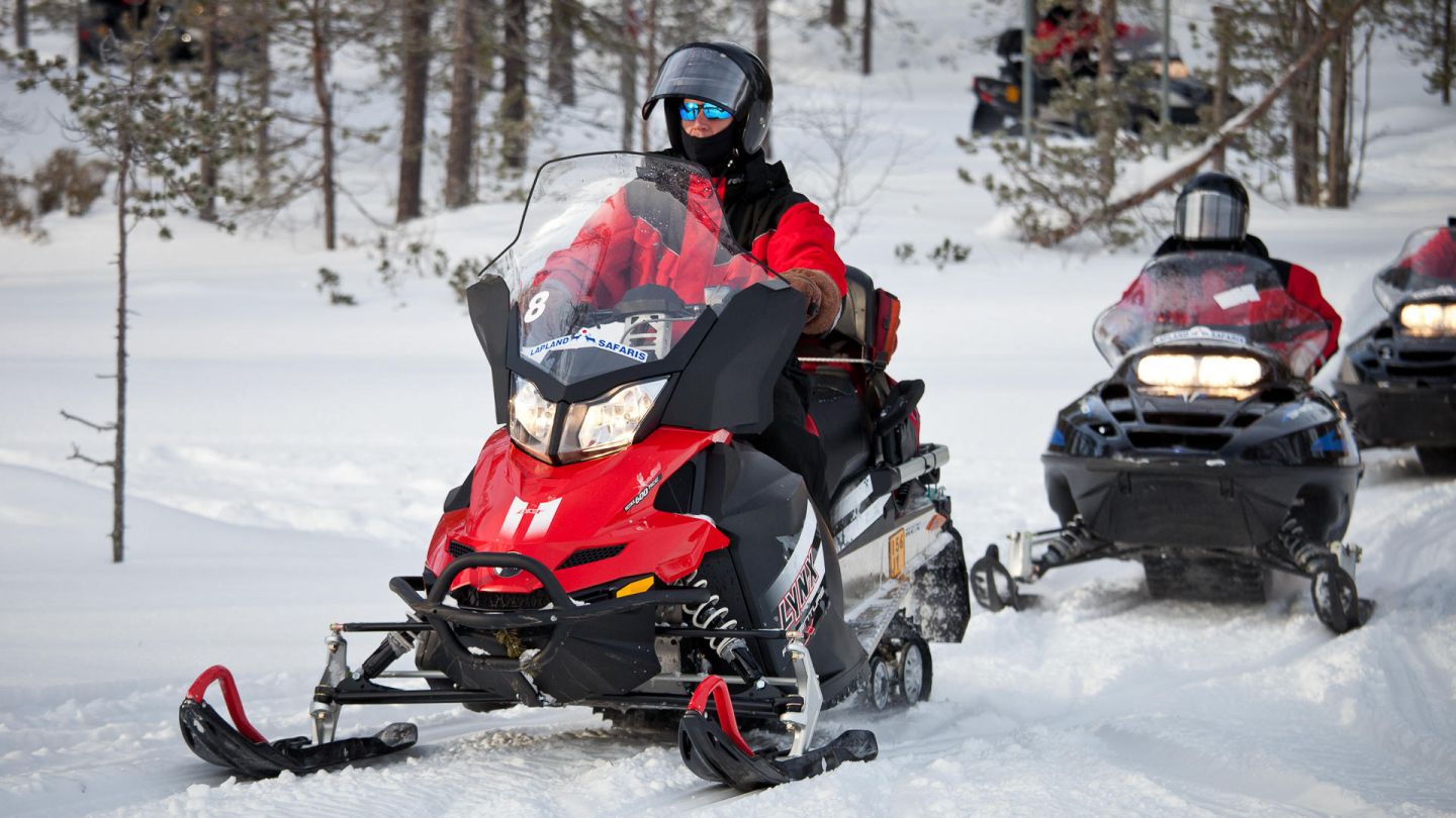 Snowmobiles under the early spring sun in Lapland, Finland