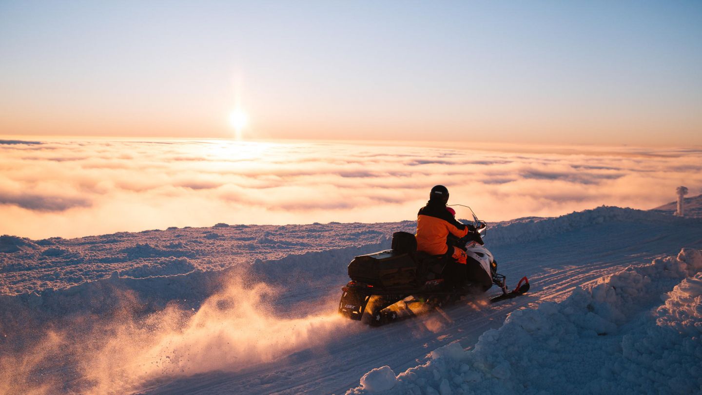 Snowmobiles during spring sunrise in Lapland, Finland