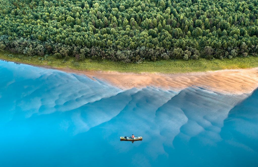 Aerial of canoe and blue Arctic waters