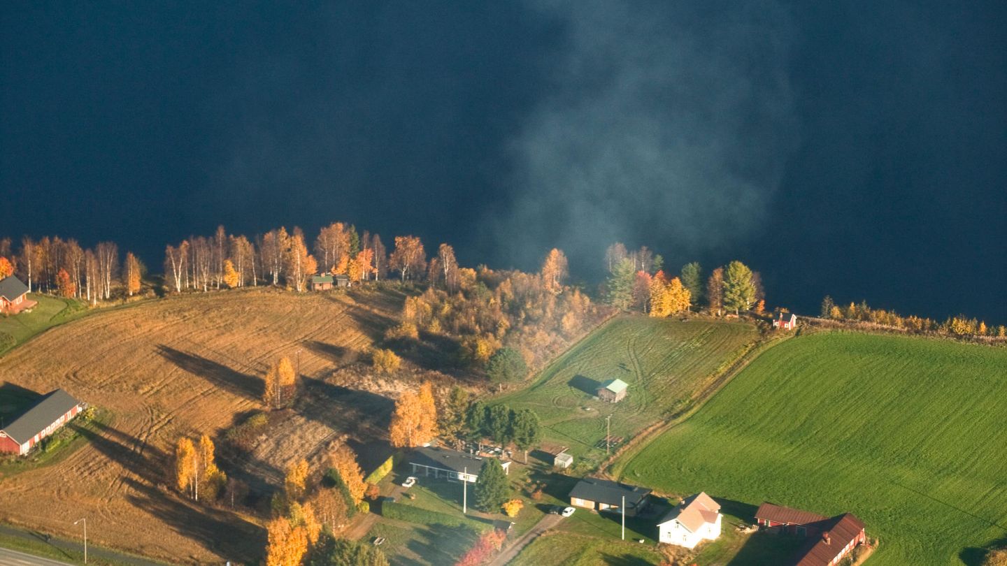 Farm by a Finnish river, filmed by drone