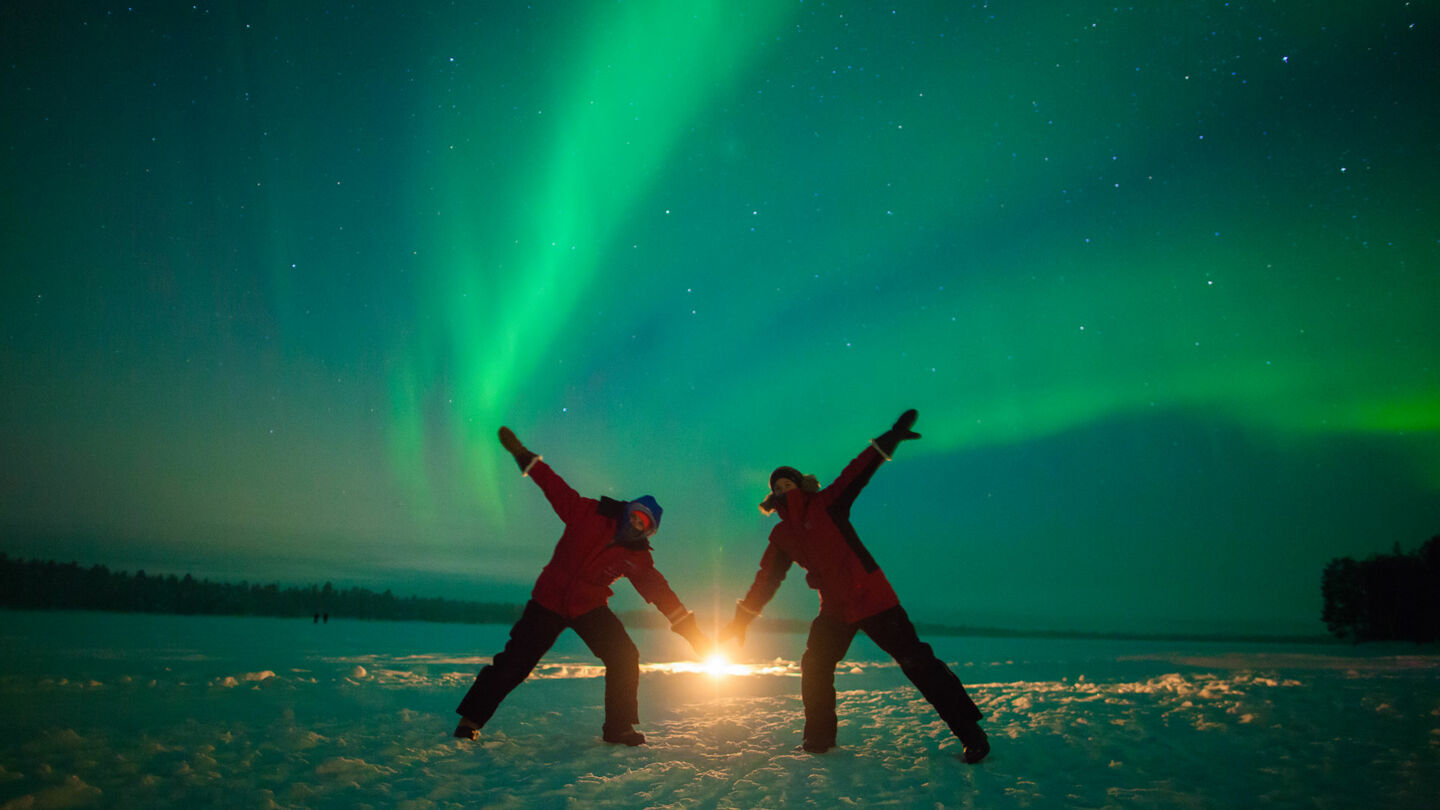 Enjoying the Northern Lights with a friend, just one of the many reasons to work in Lapland in the winter