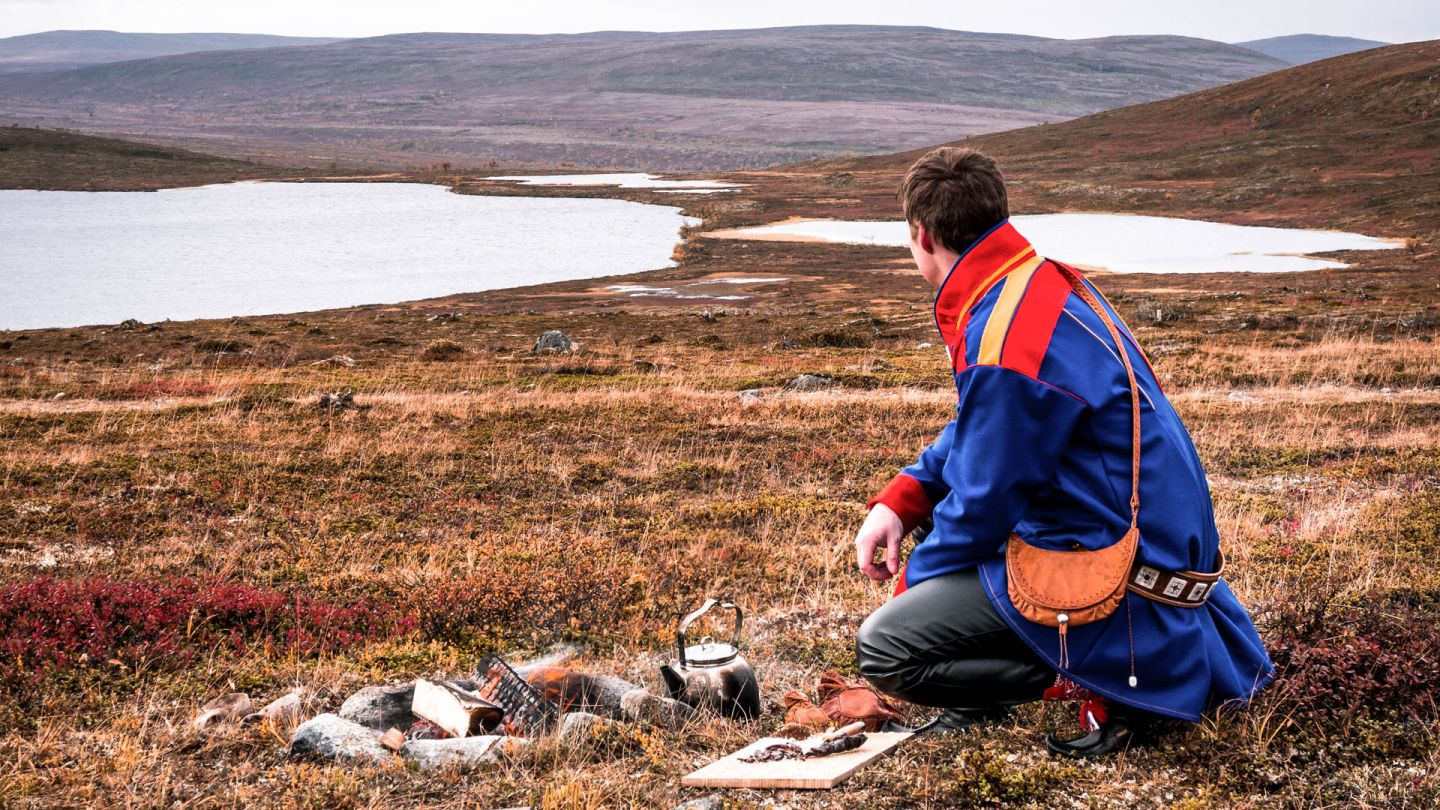 Sami reindeer herder in wilderness