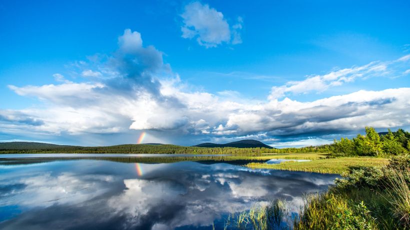 Rainbow reflecting in an Arctic Lake in summer