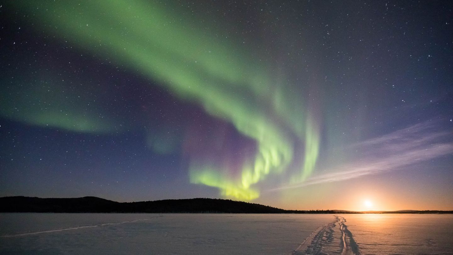 Northern lights above frozen lake
