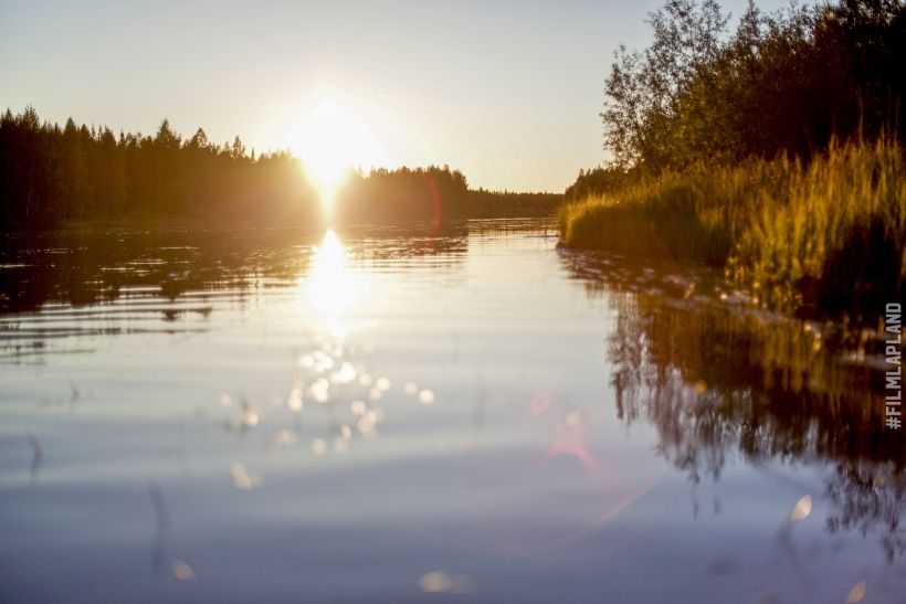 Sunset over a shimmering lake in Sodankylä, Finland