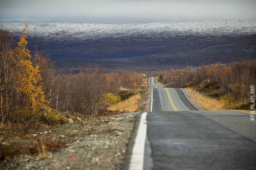 Rolling highway road in Kilpisjärvi, with Arctic hills in the distance