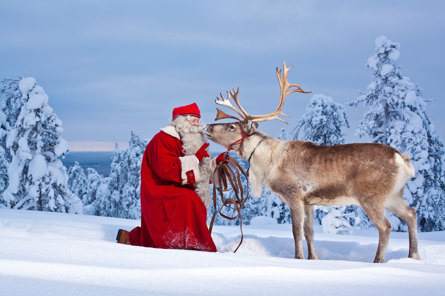 Santa claus kissing reindeer in Rovaniemi, Finland