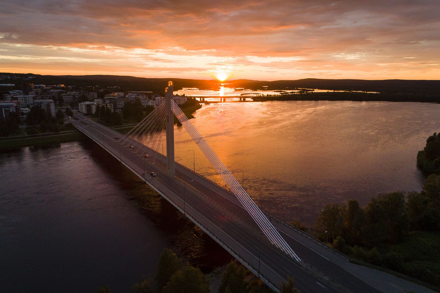 August sun behind lumbejack's candle bridge in Rovaniemi, Finland