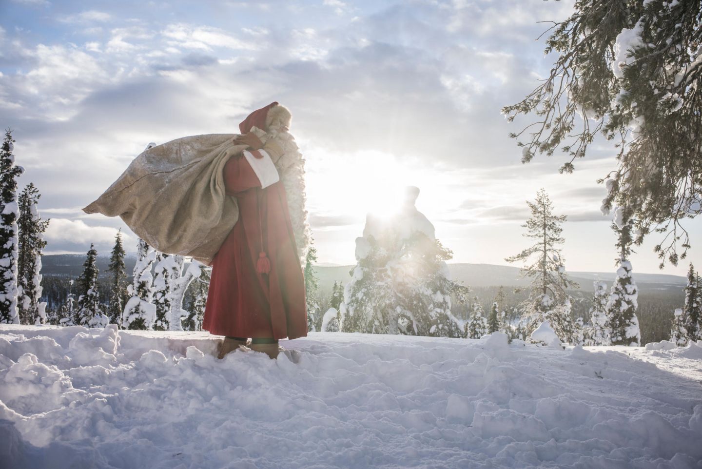 Santa carries a sack of letters and gifts in Finnish Lapland