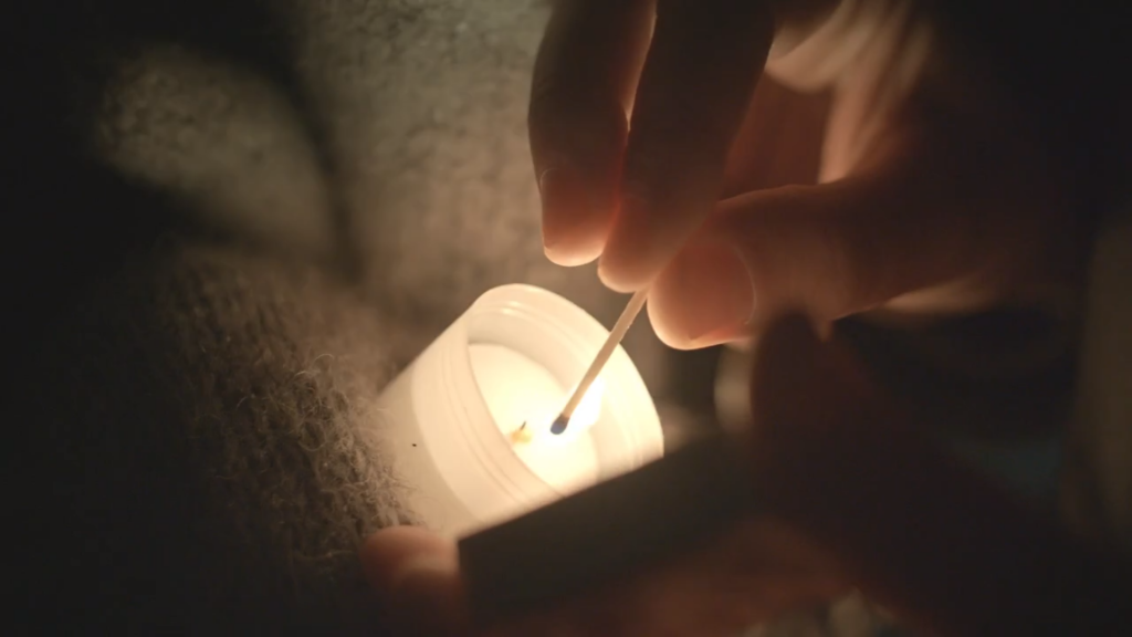 Lighting the candle in a Lapland snow lantern