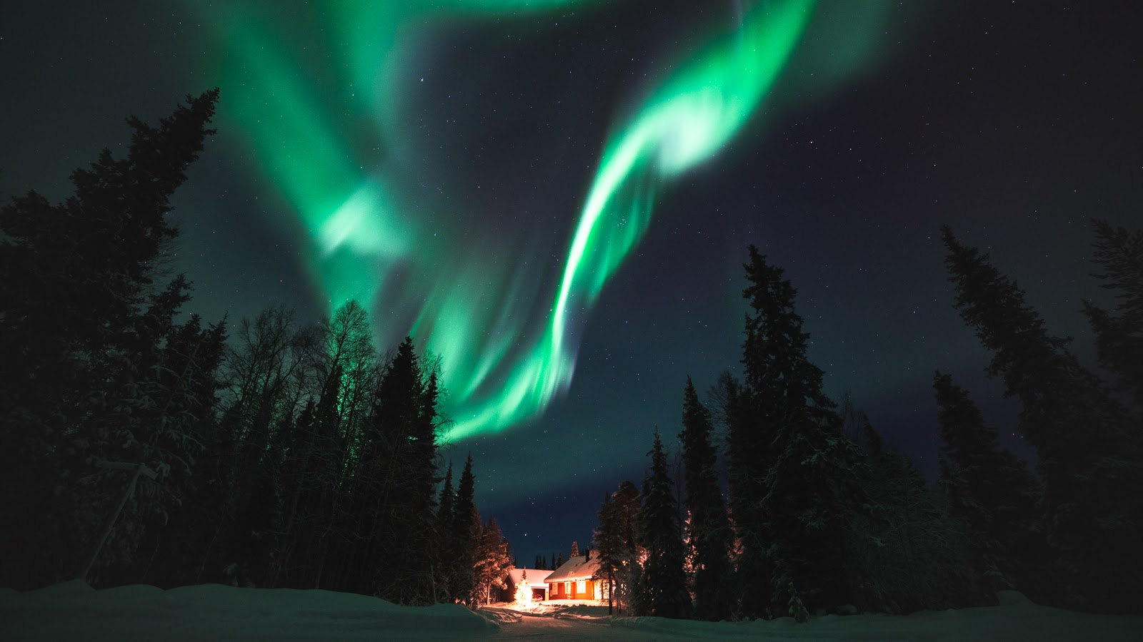 Northern Lights over a cabin in Ylläs, Lapland, Finland