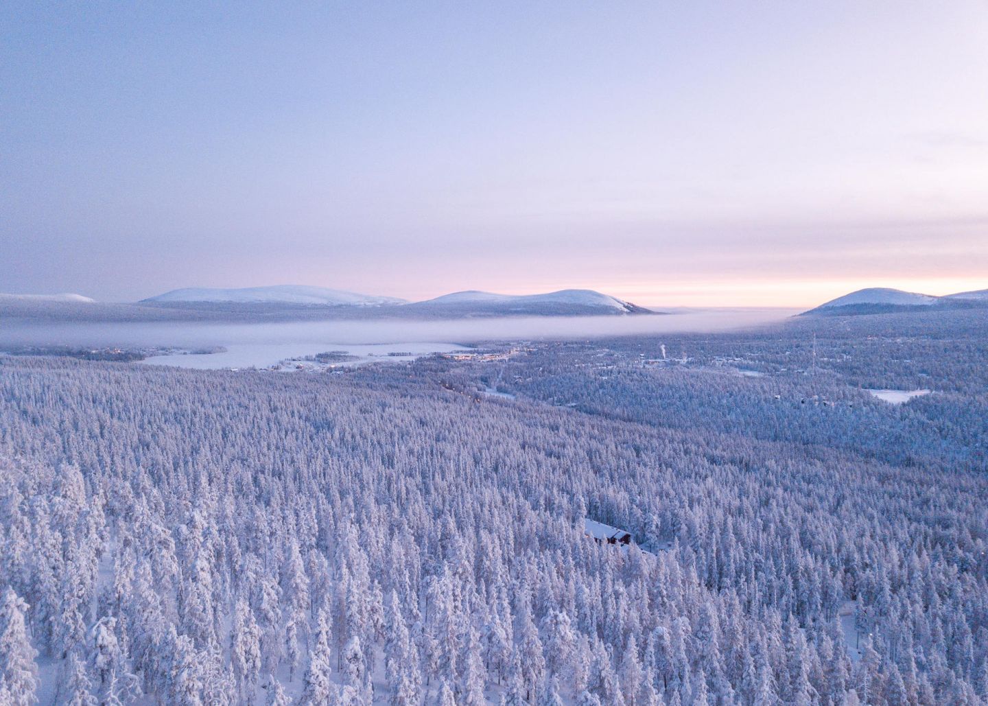 Polar night over the snowy forest in Akaslompolo, Lapland in winter