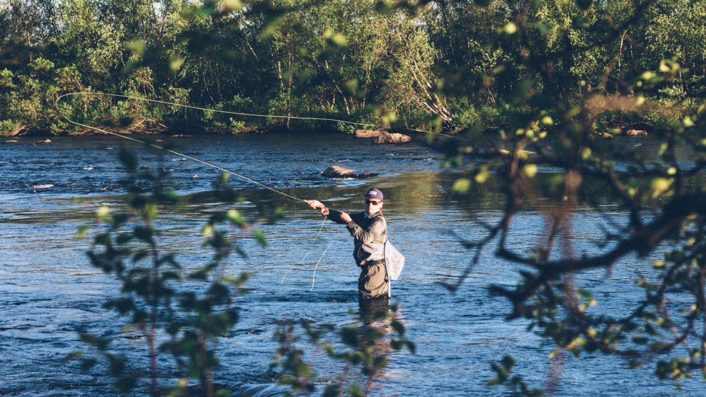 Fly fishing in river in Lapland