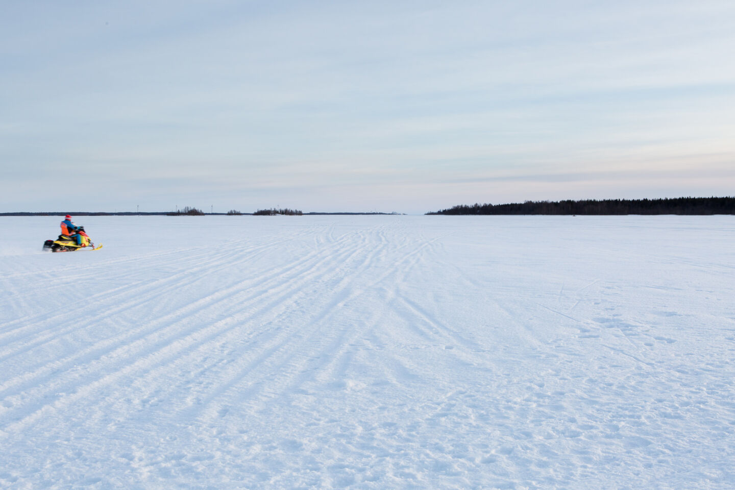 Filming snowmobiles on a frozen lake in Kemi, Finland
