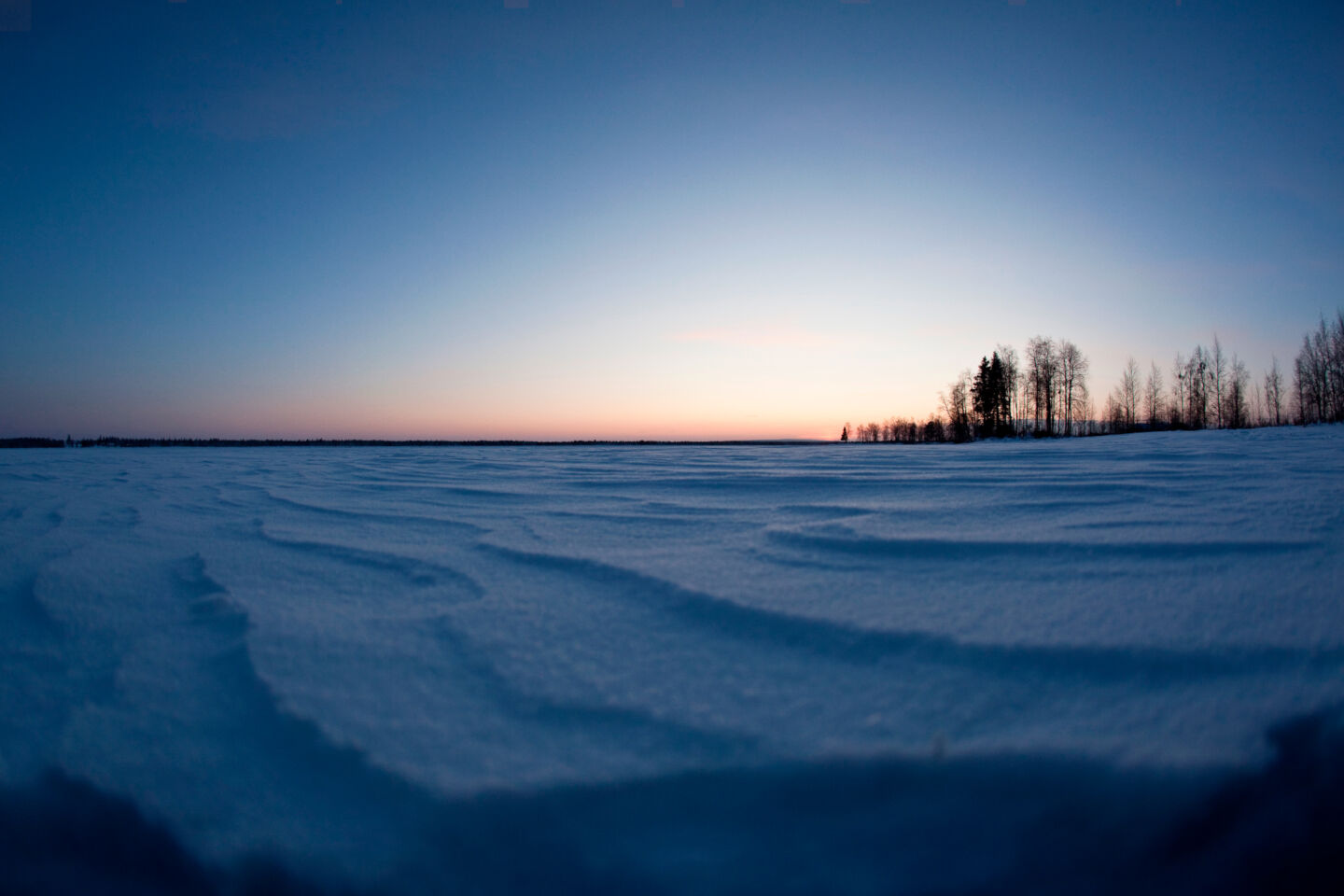 Filming sunrise over a frozen lake in Finnish Lapland