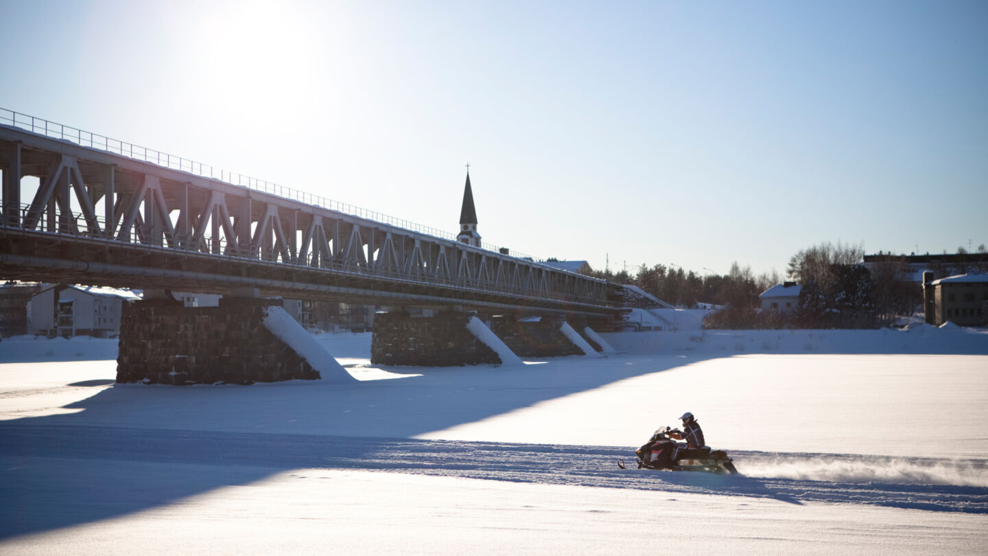 Filming snowmobiles on a frozen river