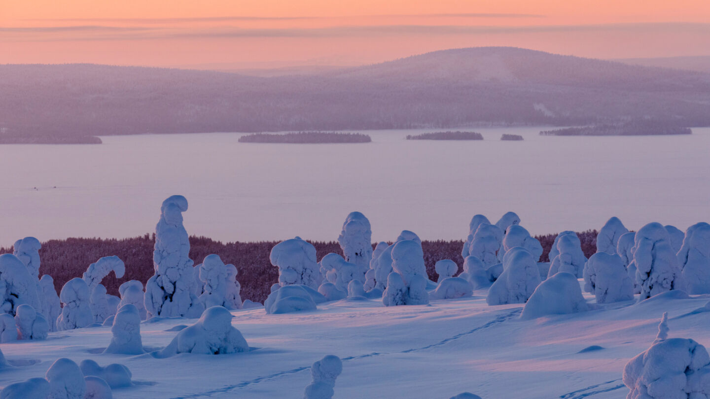 Filming sunrise over a frozen river in Posio, Finland