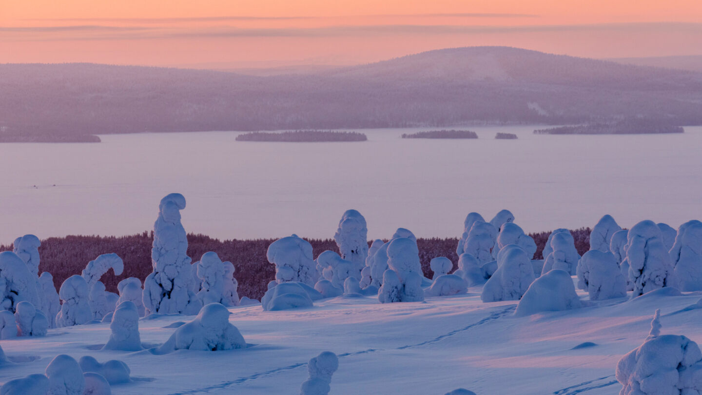 Filming sunrise over a frozen river in Posio, Finland