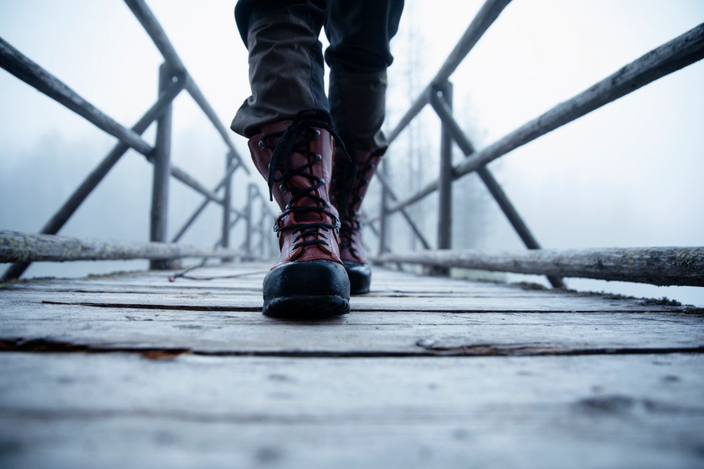 Walking across a wooden footbridge in Finnish Lapland