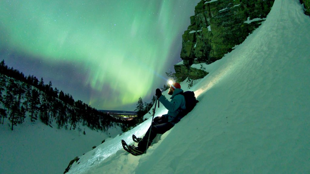 Watching the Northern Lights on a hillside in Finnish Lapland