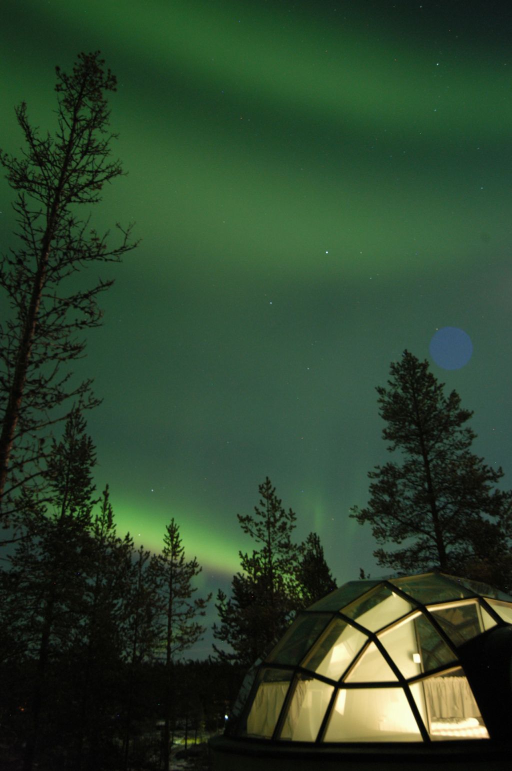 Northern Lights over Kakslauttanen glass igloos in Finnish Lapland