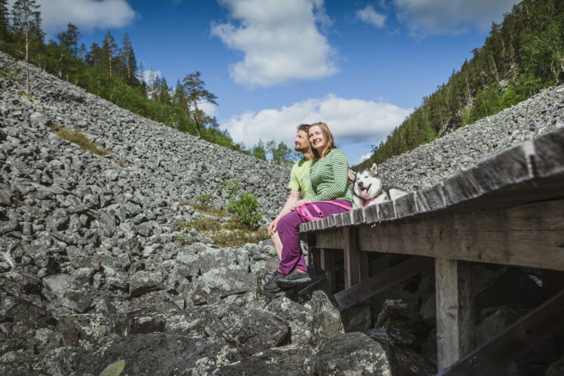 A family and dog enjoy a break on the duckboards at Isokuru gorge in Pelkosenniemi, a Finnish Lapland filming location