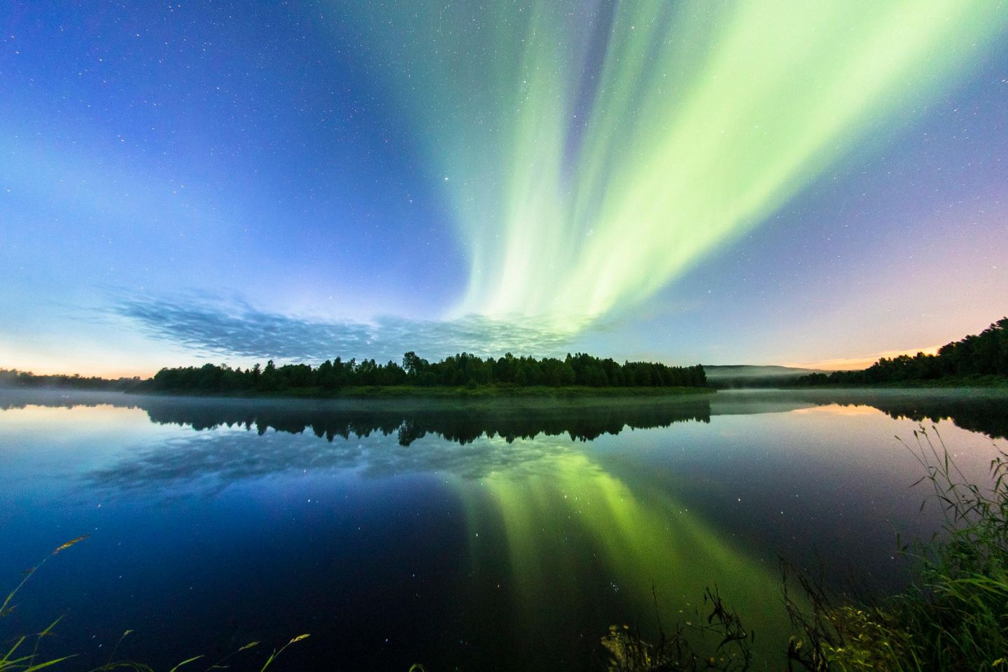 Northern Lights over the waters of Lapland, Europe's last wilderness