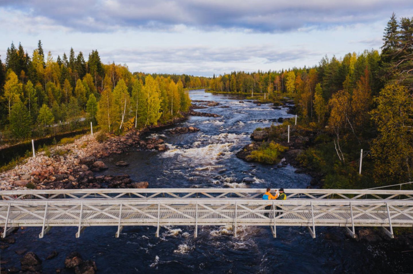 Crossing a bridge at the Arctic Circle travel Hiking Area in Rovaniemi, Finland