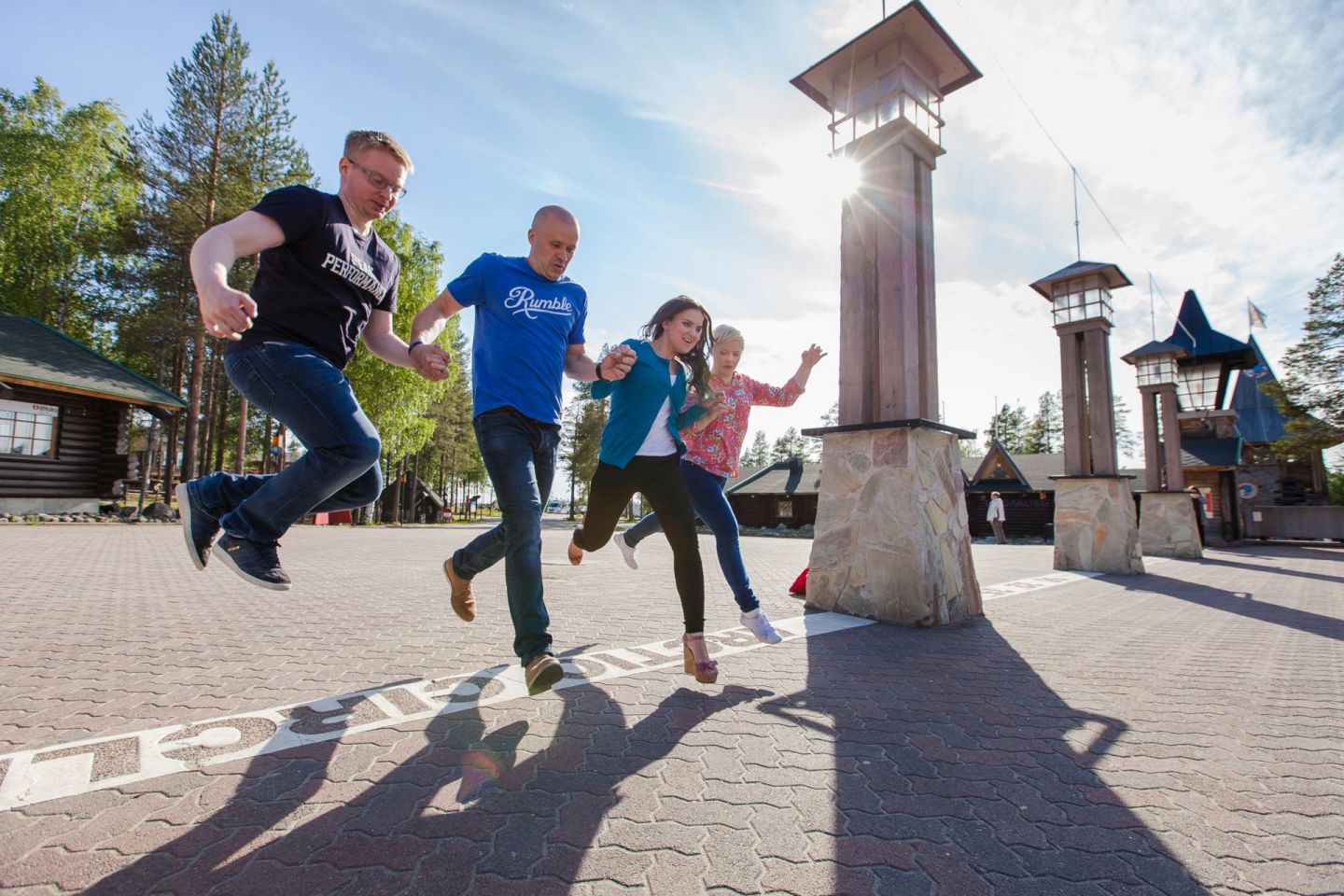 Hopping over the Arctic Circle at Santa Claus Village in Rovaniemi, Finland