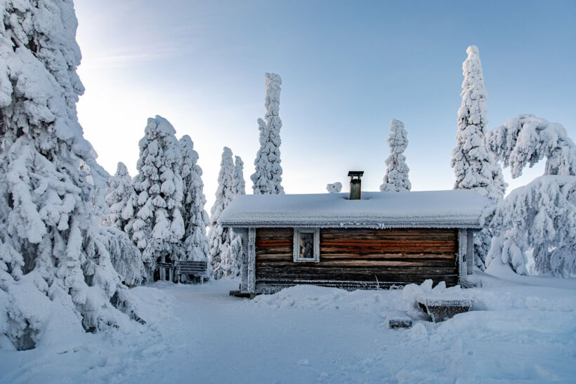 A cabin among the snow-crowned trees in Riisitunturi National Park in Posio, a Finnish Lapland filming location