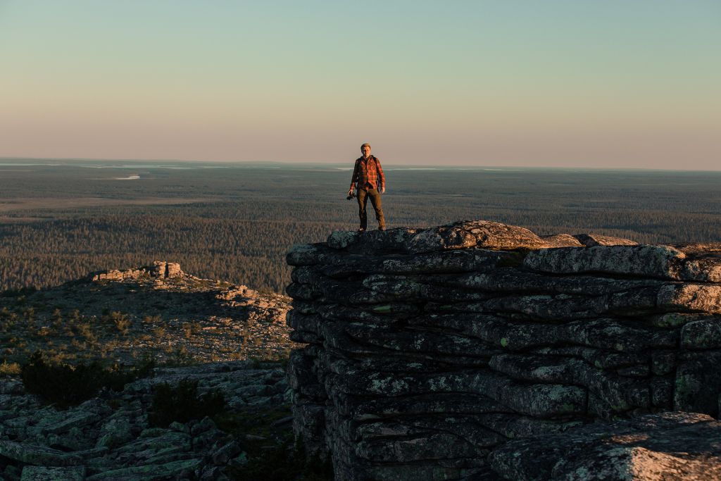 Photographer standing atop of fell