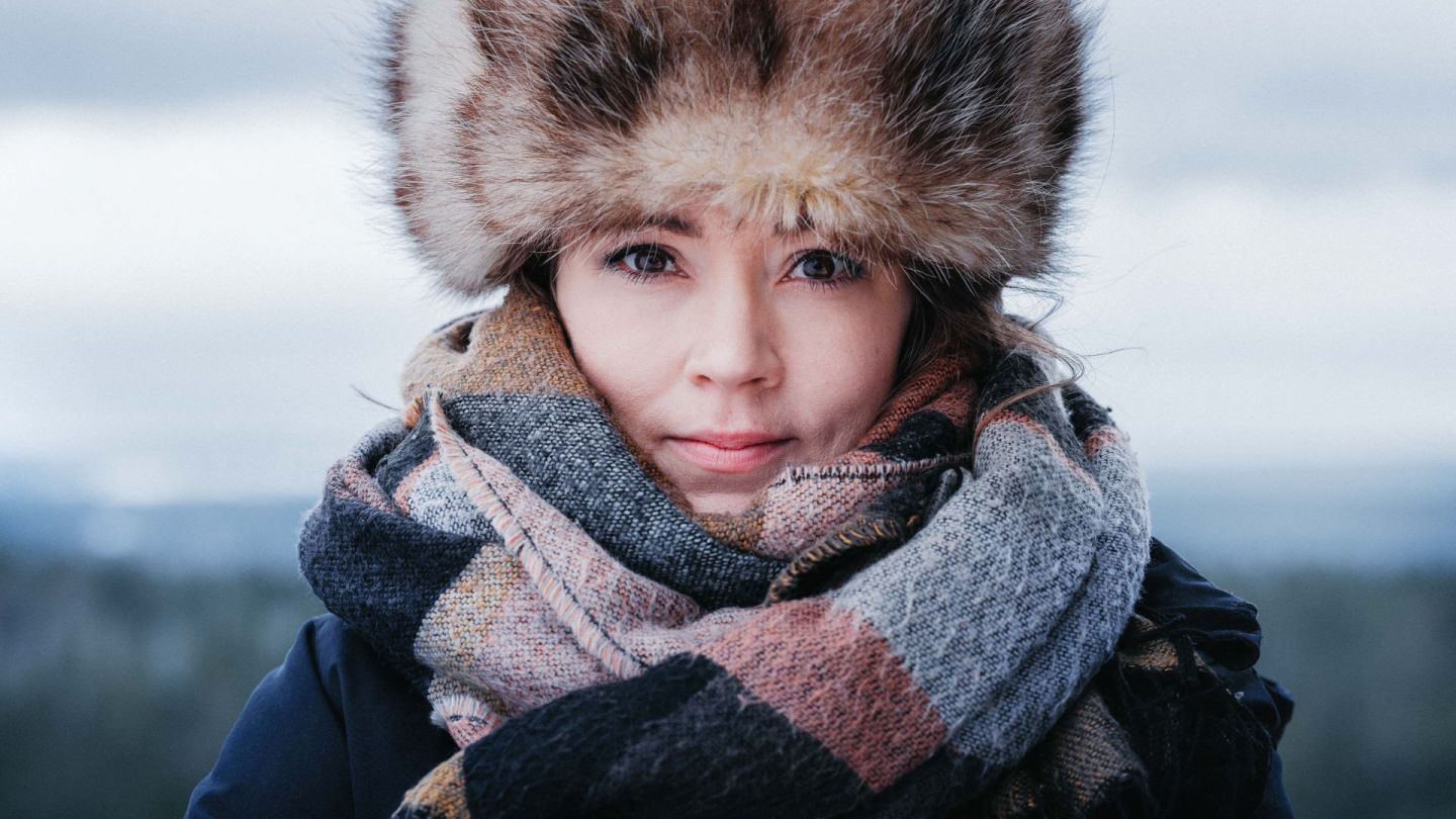 Liisa Ansala Lapland Chamber of Commerce, in a big fluffy winter hat and scarf