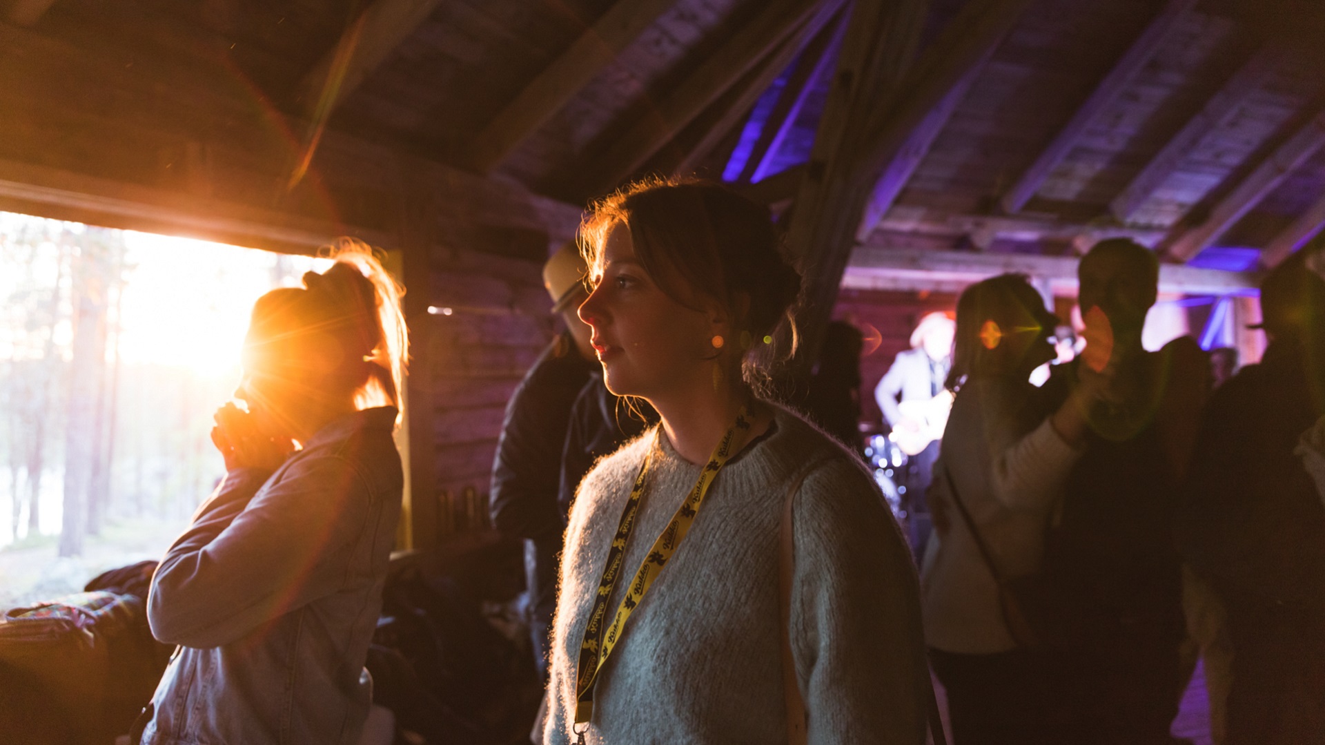 A woman surrounded by lots of people enjoying a film festival in Sodankylä.