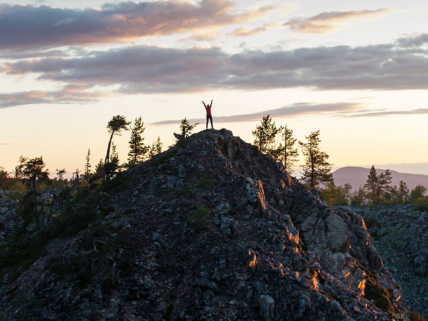 Climbing a fell during a slow travel trip to Finnish Lapland in the summer